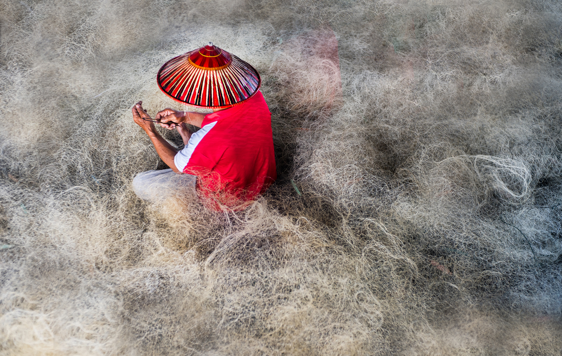 A Melanau Man Mending His Fishing Net