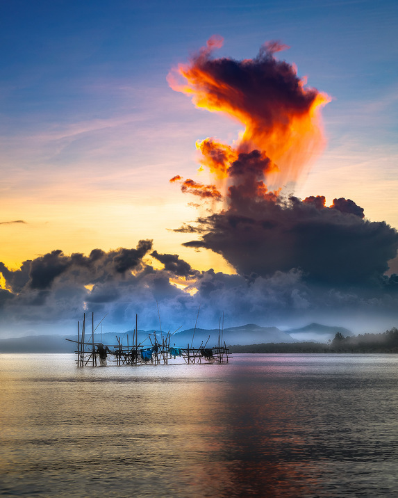 Sunrise with a cloud in the shape of a dragon at Buntal Esplanade.
